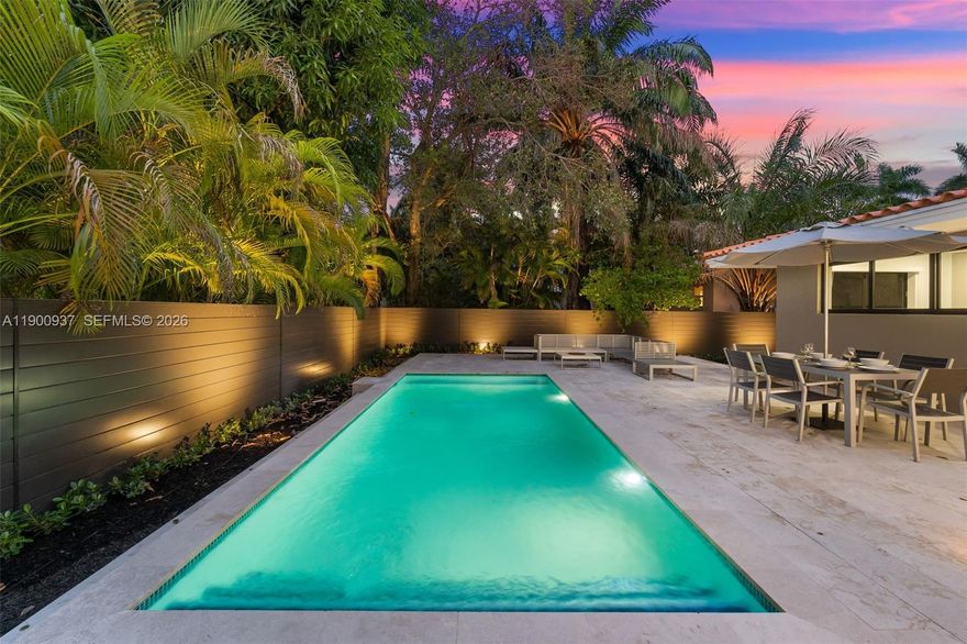 Extraordinary and refreshing, this tranquil modern home has been thoughtfully transformed by NYT Real Estate–featured designers and is ready for its first residents. The luxuriously renovated 3-bedroom, 2-bath mid-century residence sits on an oversized 10K+ corner lot near Miami Shores, blending timeless craftsmanship with refined custom finishes. A brand-new pool is framed by over 1,000 sq ft of luxury stone patios, walkways, and lush tropical landscaping with royal palms. Features include impact windows and doors, new AC, updated plumbing and electrical systems, and a fully fenced yard. The gourmet eat-in kitchen boasts custom cabinetry and premium appliances, while spacious living, dining, and den areas flow seamlessly to a private backyard oasis. Custom closets, designer blinds, laundry room, covered carport, and storage complete the home—every detail intentionally designed for you to be the first to enjoy.