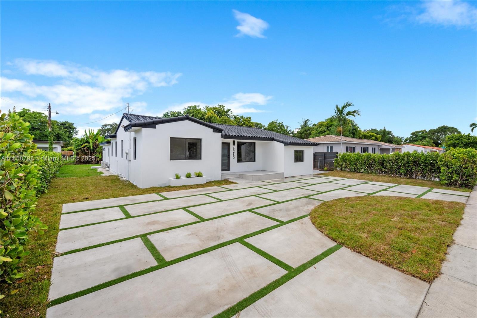 Beautifully renovated 5BR/3BA multi-generational home with a split floor plan and private in-law quarters. Enjoy peace of mind with updated roof, impact windows, and driveway. The kitchen features quartz countertops,a farmhouse sink, a hood, and plenty of lighting that makes the home feel warm and inviting. Zero-entry showers add style and accessibility. Over 2,000 sq ft of move-in-ready comfort deal for a large family or rental income. Oversized lot has room for a pool plus space to park a boat on each side. Just bring your toothbrush every detail is done!