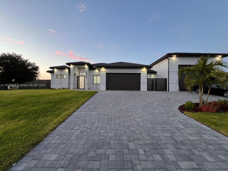 Luxury home on a 0.37 acre lot in one of Cape Coral fastest growing areas. This 4 bedroom, 4 bathroom home offers a total of 4,176 sqft, with 1,909 sqft under air in the main house. It features 12-ft ceilings, an open-concept layout, spray foam insulation for maximum energy efficiency, and high end finishes throughout. Enjoy a 28x14 ft heated saltwater pool with spa, a 1,400 sqft terrace, and a stylish summer kitchen. The 1,440 sqft garage with 16ft ceilings accommodates RVs or boats includes a 24x10 office and 24x10 guest suite with a full bathroom. Ideal for luxury living or investment, with potential for a private business or separate rental unit fully detached from the main home. Additionally, there is a second garage for two vehicles and quality appliances, including washer and dryer.