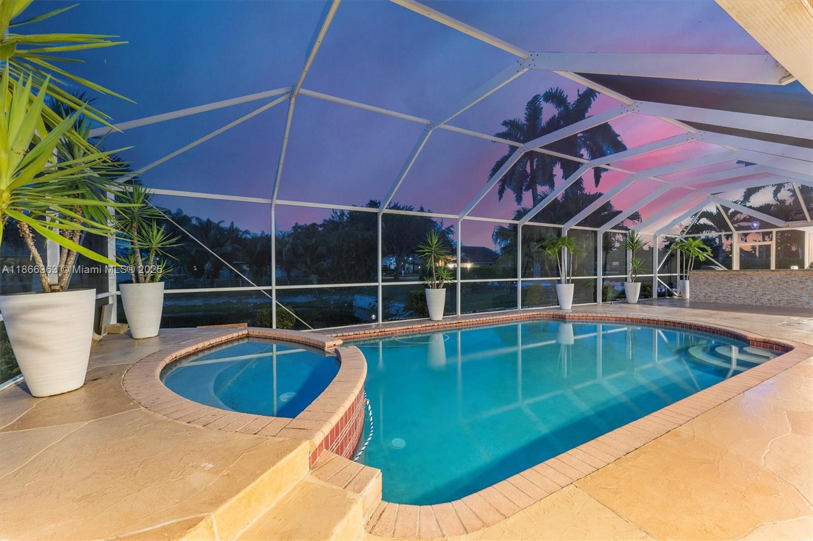 Beautiful 4-Bed, 2 Full & 2 Half Bath single-story home in gated Carriage Pointe Estate. Set on a large corner waterfront lot with lush landscaping, this residence offers an open layout with formal dining, living & family rooms. Gourmet kitchen features granite counters & stainless steel appliances. Light-filled interiors boast porcelain floors, laminate in bedrooms, custom closets, and upgraded baths. Primary suite includes a sitting area, dual sinks, Roman tub & shower. Screened, heated pool with covered patio, built-in BBQ bar & lake views. New A/C 2023, roof 5 yrs, water heater 2024. Large laundry & 2-car garage. Close to Sawgrass, schools, dining & parks. Mortgage savings may be available for buyers of this listing.