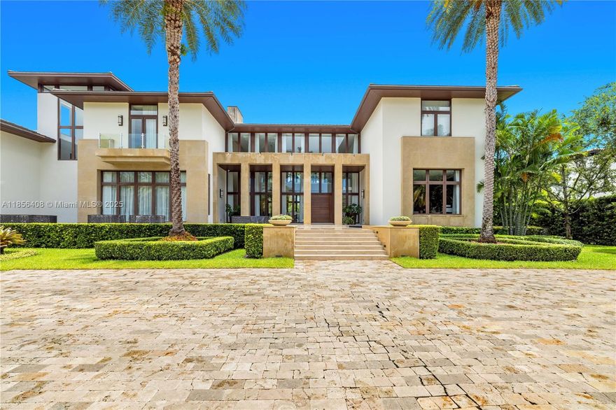 Presenting a breathtaking waterfront mansion that defines sophistication. Set on a 40,511sq ft lot with 180ft of prime water frontage and private dock, this residence offers the ultimate Miami lifestyle where elegance meets serenity. Spanning over 12,173sf, this architectural masterpiece boasts 7 bed, 7 baths, 2 powder rooms. Thoughtfully designed with multiple social and entertainment areas, including a library, and exquisite lounges ideal for hosting. Every detail reflects the owner's discerning taste from the rich custom wood finishes to the sleek marble floors throughout. Kitchen equipped with top-of-the-line Miele appliances, Temperature controlled wine cellar. The estate offers a gym and private staff 2 bedrooms quarters for seamless living, full generator, elevator, 4 car garage.