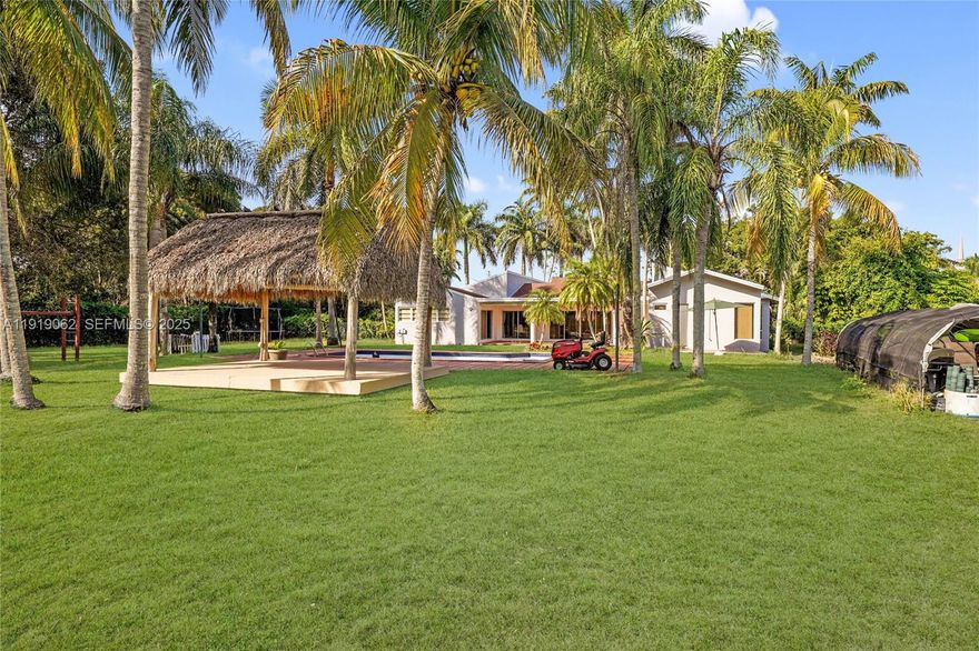 Exceptional home in a great location at an outstanding price. This spacious residence offers 4 bedrooms, 2 and 1/2 bathrooms, and an attached 2-car garage, situated on an expansive 42,035 SF corner lot. The home features generous living areas filled with natural light, including formal living and dining rooms that overlook the pool and patio.The large eat-in kitchen flows seamlessly into a comfortable family room, currently set up as a home theater. The fully fenced property is ideal for both privacy and entertaining, complete with a sparkling pool, Tiki hut, children’s play area, and a covered terrace. Convenient circular driveway provides ample parking, with plenty of room for a boat or RV.Located close to major roadways, schools, entertainment, and more—this home is a must-see and should be at the top of your list.