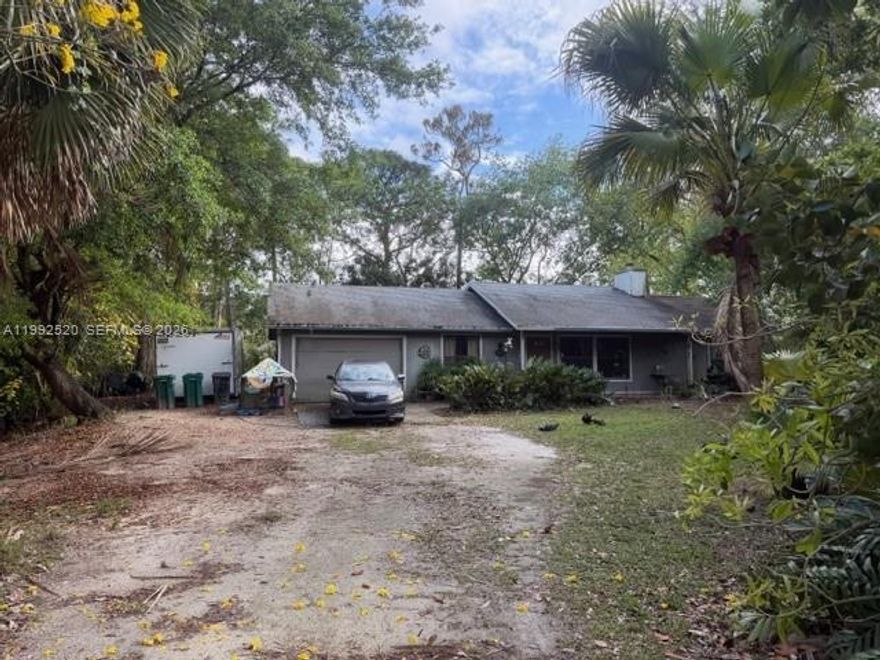 HOW ABOUT THE PERFECT LOCATION FOR BUILDING YOUR PARADISE???  THIS 1.15 ACRE LOT HAS IT ALL - FENCED, POND, LOADS OF TREES AND PRIVACY!!  THIS 3 BEDROOM, TWO BATH HOME HAS A NEW ROOF IN 2023 AND PLENTY OF SPACE TO RENOVATE IT TO YOUR LIKING - SPLIT BEDROOMS, MASTER WITH WALK IN CLOSET, MASTER BATH WITH WALK IN SHOWER.  ADDITIONAL BEDROOMS WITH SPACIOUS CLOSETS, 2ND BATHROOM HAS TUB/SHOWER COMBO AND ROOM FOR DUAL SINKS.  CHEFS KITCHEN WITH NEW REFRIGERATOR, STOVE, MICROWAVE - LOTS OF CABINETS, COUNTER SPACE, EAT IN KITCHEN AND PASS THROUGH TO LIVING ROOM.  LIVING ROOM WITH FIREPLACE FOR THOSE COOLER EVENINGS IN THE WINTER.  LOTS OF NATURAL LIGHT.  SEPARATE LAUNDRY ROOM LEADING TO 2 CAR GARAGE.   FRENCH DOORS LEADING TO LARGE SCREENED PATIO OVERLOOKING THE EXPANSIVE GARDEN WITH MATURE TREES.  NO HOA - YOU CAN DO WHATEVER YOU WISH ON THE LAND - BRING HORSES, CHICKENS, GOATS - PLENTY OF SPACE TO ADD A POOL OR EVEN AN IN-LAWS QUARTER.  NEW REVERSE OSMOSIS WATER FILTRATION SYSTEM.  HOME SITS HIGHER ON LAND SO NO FLOOD ZONE.   UNDERGROUND ELECTRIC, CABLE AND INTERNET AVAILABLE.  WITH WELL WATER THERE IS NO WATER BILL!!!  LOTS OF WILDLIFE TO ENJOY!!   FOR THE RIGHT BUYER, THIS HOME IS WAITING TO BE YOUR OASIS AWAY FROM THE HUSTLE AND BUSTLE OF THE CITY BUT CLOSE ENOUGH TO ENJOY ALL THE RETAIL NEARBY.   SCHEDULE YOUR SHOWING TODAY - AND DON'T FORGET TO CHECK OUT THE NIGHT STARS AND QUIETNESS FROM ANYWHERE ON THE PROPERTY!!!