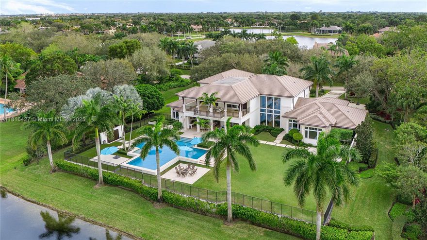 A True Trophy Estate | Designed by acclaimed architect Randall Stofft, nestled within the most exclusive and
coveted gated community in Weston, Windmill Ranch Estates. This remarkable 13,876 total SF contemporary
masterpiece's great room welcomes you with spectacular views of its expansive yard, resort-sized pool and
unparalleled lake panorama. The warm palette of its natural marble flooring throughout, exudes elegance and
sophistication. The spectacular Downsview kitchen is equipped with top-of-the-line appliances, with a summer
kitchen that provides a seamless indoor-outdoor lifestyle experience. This estate has it all; club room, gym, dual
offices, smart home, music room, detached 1,500sf space for custom guest house, and much more. Completed in 2017. 225' water frontage.