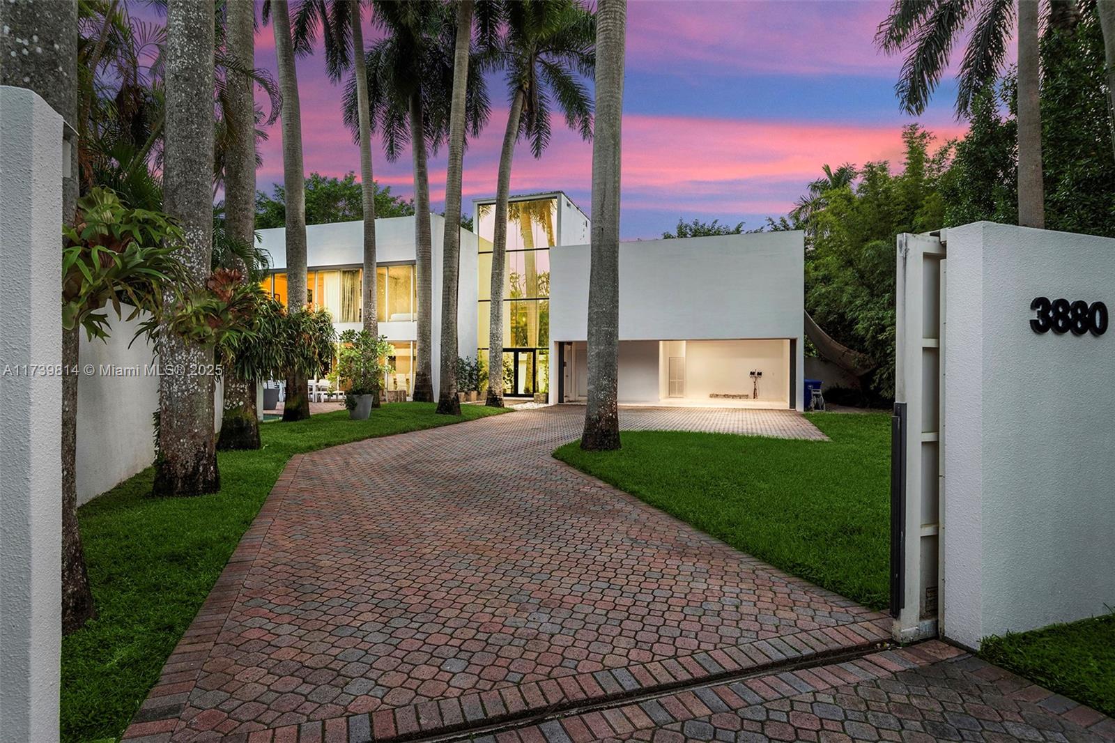 As you step into this fully enclosed and gated modern estate in the prestigious South Grove area, you’ll find yourself in a secluded haven surrounded by beautiful mature palm trees, framing a sleek two-story pool house. The ground floor is perfect for hosting gatherings, offering elegantly designed dining, living, and lounge spaces that open up to an inviting pool, and a lush garden. The second floor is home to all five bedrooms, including a large primary suite, spread across two separate wings. The property also features a covered garage for two cars, with additional outdoor parking available. This home is fully furnished with beautiful top of the line furniture and finishes.