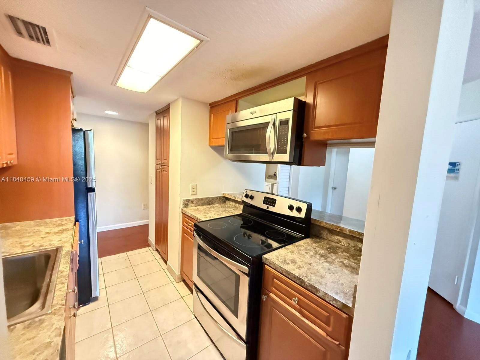 Spacious 2-bedroom, 2-bath in the gated community of Palm Aire Gardens. This bright unit features a split floor plan, wood floor throughout, and an in-unit washer and dryer for added convenience. Enjoy a functional kitchen with open access to the living and dining areas, plus a private balcony with peaceful garden views. Community amenities include a pool, gym, and clubhouse. Conveniently located near major highways, shops, restaurants, and parks. Move in and enjoy comfort and convenience in a well-maintained community!
