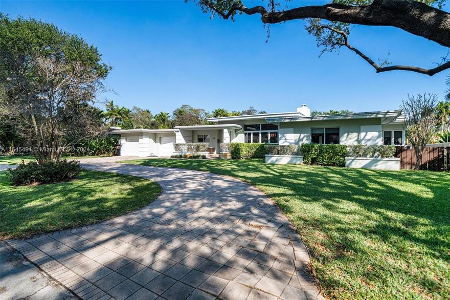 Updated mid-century modern home with hardwood and terrazzo floors. Expansive master suite, stylish kitchen with granite countertops. Hurricane impact windows, new electric and plumbing. Step outside to discover a lush tropical oasis in the private backyard, complete with a covered patio and inviting pool, all nestled on an expansive lot. This is an exceptional property. Must-See!
