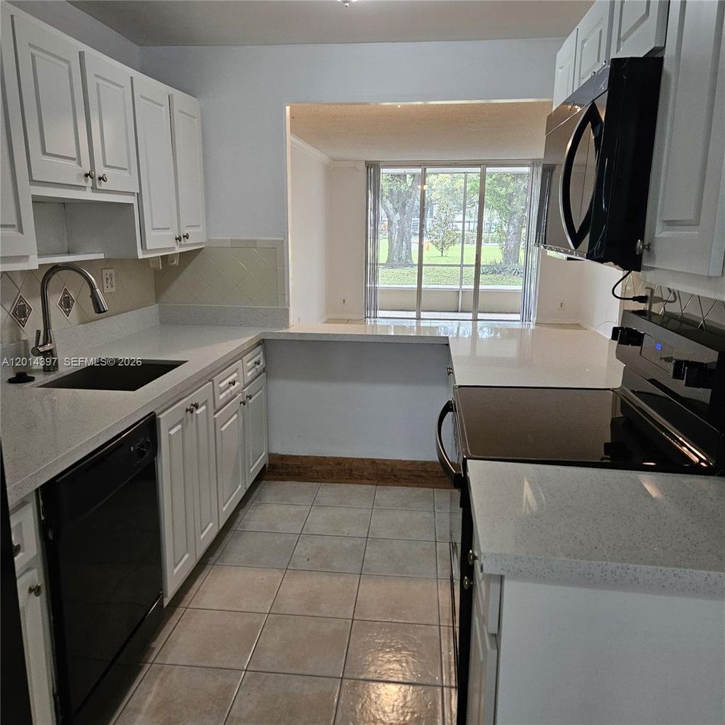 Photo of 3070 NW 48th Ter #104, Lauderdale Lakes, FL 33313 (MLS # A12014397)