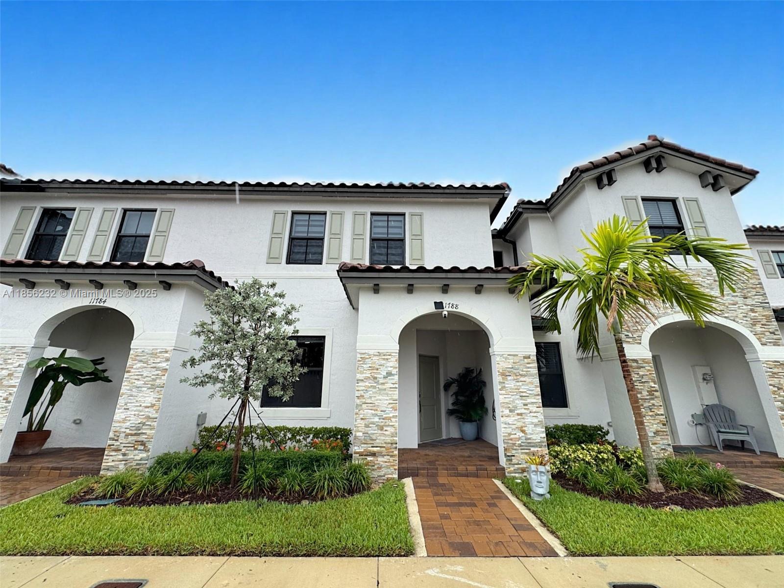 Beautiful modern townhouse in Silver Palms featuring unique custom touches throughout. Enjoy enhanced ambiance with extra lighting, sleek modern wall panels, and smart light switches for added convenience. Step outside to a charming pergola-covered turf backyard complete with a built-in grill island, perfect for entertaining. Remodeled wooden stairs and a full wooden second floor add style and warmth to this spacious home offering 3 bedrooms, 2.5 baths, closets with custom cabinetry, window treatments, a convenient washer and dryer inside, 2 private parking spaces, and an electric vehicle charging station. Located near the Turnpike for easy commuting. The community offers a refreshing pool, gym, and social areas for events.