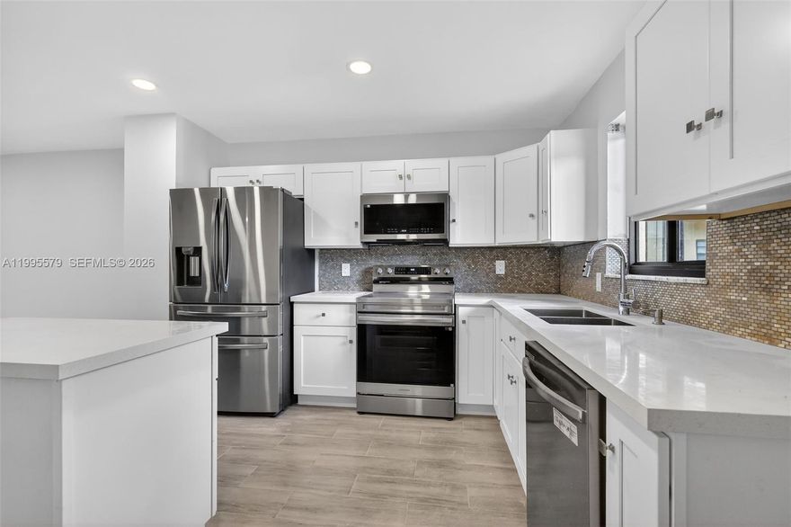 Beautifully remodeled 2 bedroom, 2 bath condo located in the gated community of Villas at Carriage Hills! This is an all ages building. This stunning first floor unit features a modern open concept great room floor plan with sleek tile flooring throughout. The updated kitchen boasts elegant white cabinetry, brand new stainless steel appliances, and a stylish island, perfect for entertaining. Two spacious bedrooms, 2 bathrooms, ideal for privacy, along with generous storage and a walk in closet. Enjoy relaxing in the screened in patio, adding extra living space and comfort. Residents enjoy a scenic walking trail around the lake, BBQ areas, fitness center, sauna, game room, basketball and tennis courts, and many other amenities. Prime location in the heart of Hollywood, just across the street from shopping, restaurants, and banks, and only minutes from Nova Southeastern University, the Hard Rock Guitar Hotel & Casino, major highways, and Fort Lauderdale International Airport.