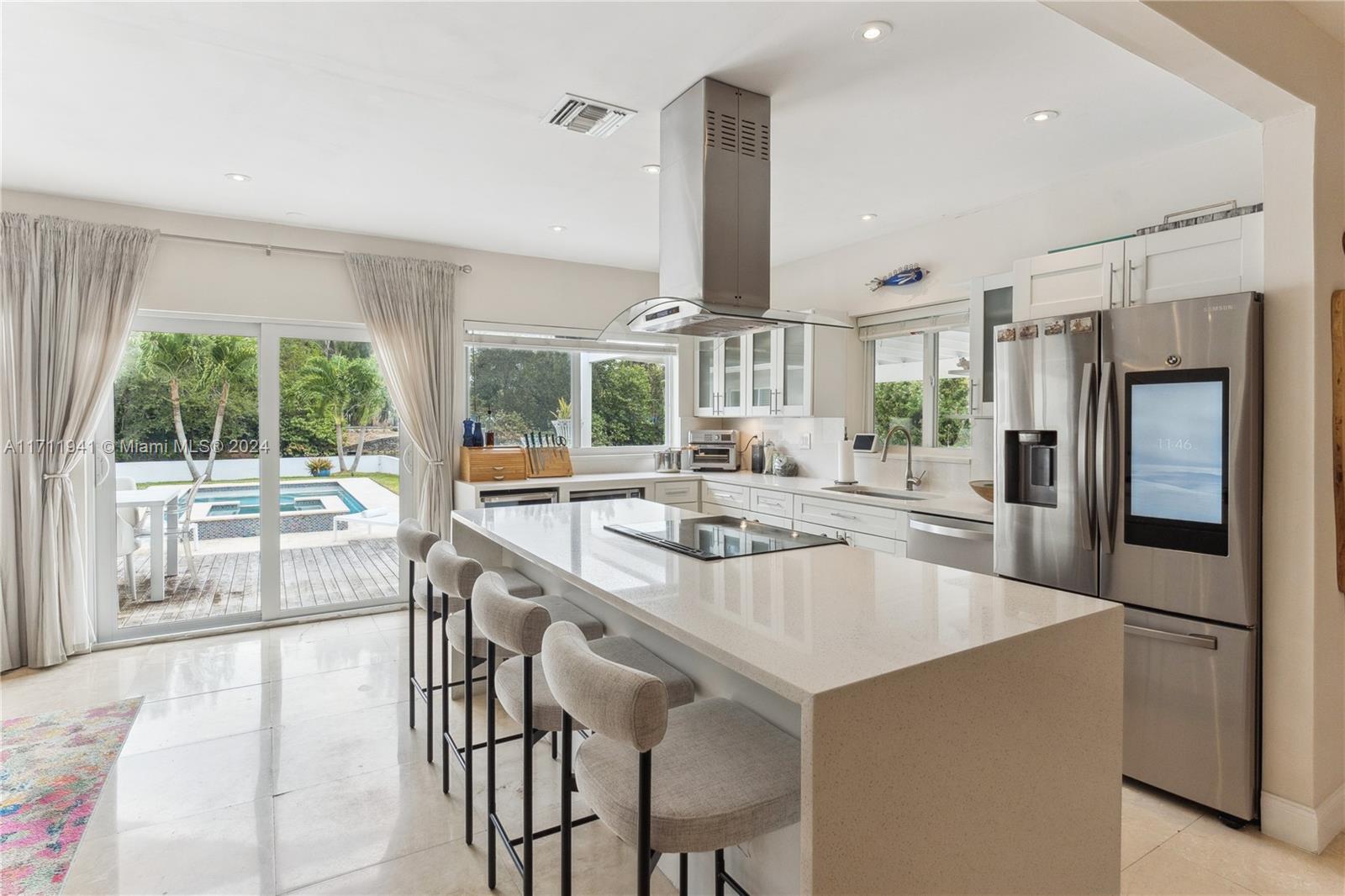 Discover Casa Del Rio! A 3/3, 2,500+ sq/ft waterfront home on close to a 1/3 acre lot where modern luxury meets thoughtful design. Your home boasts a spacious open layout, abundant natural light, & an expansive outside area featuring a teak deck & full outdoor kitchen. The landscaping includes mango/lychee/lemon/avocado/banana trees, complementing a saltwater pool/spa for ultimate relaxation. This hurricane proof, move-in-ready home offers a Generator, 2 brand-new AC's, & an upgraded electrical system. The 1.5-car garage features refinished floors, slat storage walls, a washer/dryer, & Fridge. Fully automated smart home controls manage lights/fans/blinds/pool functions. Minutes from I-95 & enclosed by a steel fence w/ 2 automated gates, Casa Del Rio is waiting for you.