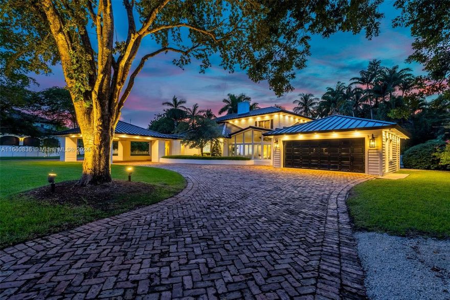 Serene Coastal Contemporary Estate on a 47,480 SF Gated Lot with TENNIS COURT on the quietest street in North Palmetto Bay! Upon entry, your bright foyer opens to expansive living areas & formal dining, which adjoins a kitchen equipped w/ Monogram appliances, Miele Coffee Maker, large island, & elegant wood cabinetry w/ quartz counters. Large family room w/ floor-to-ceiling impact windows by the Kitchen. Primary Suite ftrs a seating area, spa-like bathrm, & one of the largest walk in closets in Palmetto Bay! Make memories in the Tuscan inspired Wine Room w/ temp. controlled wine cellar. Primary + 1 ensuite bdrm downstairs & 2 large ensuite bdrms upstairs. Backyard tropical oasis w/ mature landscaping, resort-like pool & spa, & tennis court w/ 8 professional lights. Close to Top Schools!