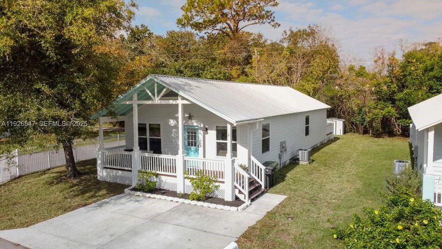 Discover coastal living at its finest in this charming cottage tucked away in a marsh-side neighborhood, just minutes from Vilano Beach and Historic Downtown St. Augustine.

This turnkey furnished income producing (AirBnB), light, bright, and airy home features an inviting open floor plan with vaulted ceilings and abundant natural light perfect for relaxing or entertaining. The property offers durable metal roof and siding.

The layout is thoughtfully designed with two guest bedrooms at the front of the home and the primary suite positioned privately at the rear, complete with an ensuite bathroom and direct access to the spacious back deck. Laminate wood flooring flows throughout the home for a clean and cohesive look.

The eat-in kitchen features a center island, granite countertops, white cabinetry, stainless steel appliances, and sliding glass doors that open to the backyard. Enjoy Florida living year-round.