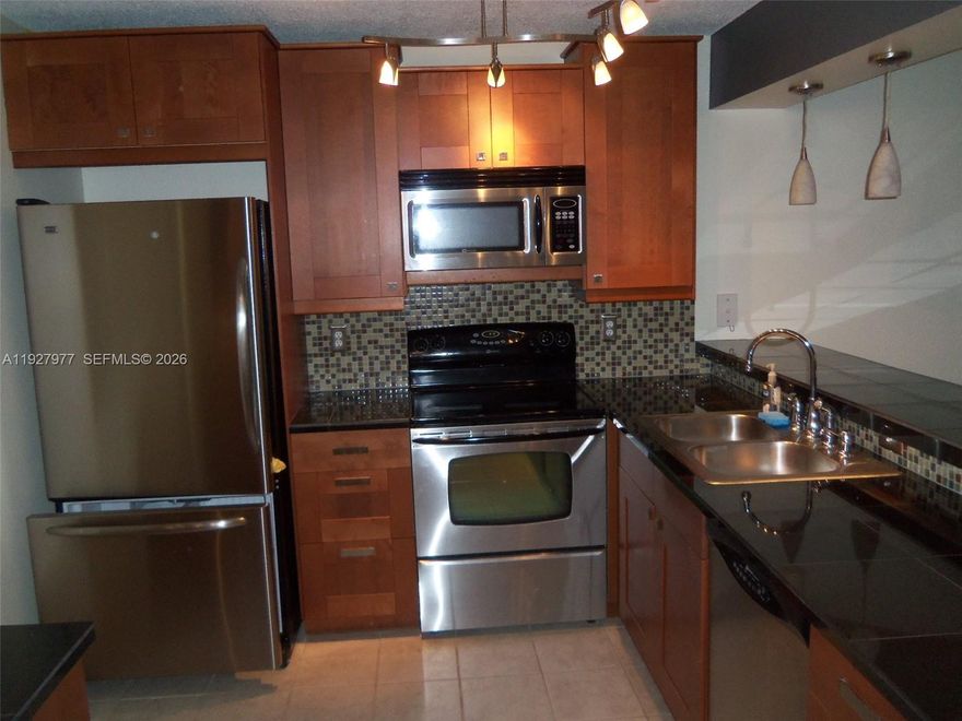Stunning updated 2/2. Ideal location with easy access to major highways, walk to shops, Sawgrass Mall, restaurants. This condo features eat in kitchen, granite countertop, stainless steel appliances, fancy back splash, double sink, washer, dryer, patio with extra storage, wood floors in living, dining and bedrooms, ceiling fans in every bedroom and living room, screened patio overlooks pool and tennis courts. Accordion Shutters. A must see. Live in style and comfort.