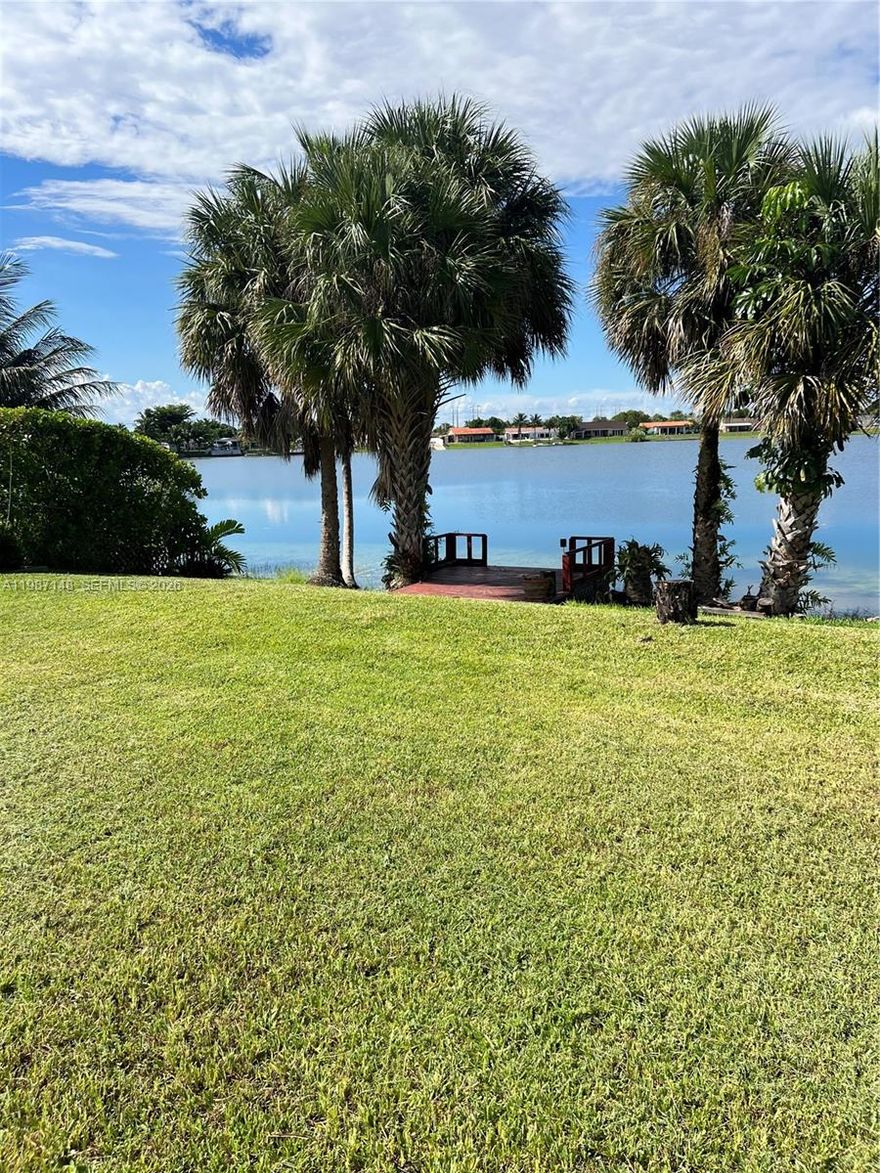 Relax in you beautiful lake front home !! South Florida living at its best with private dock, large covered terrace  and over 13,000 Sq Ft of lot area. This 3/2 with an extra bedroom/office with closet space. Home offers a NEW ROOF , A/C System and Water Heater along with a new dishwasher and gas range. Only home on the lake on the market !!! NO HOA. Close to restaurants, schools, shopping, hospital and the Florida turnpike. Wide views of the lake and vast yard call for fun in the sun all year around.