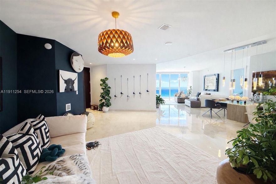 Spectacular ocean views from multiple exposures.  3-bedroom layout potential, den can be enclosed to create a true third bedroom.  Features include floor-to-ceiling windows, 10-foot ceilings, custom-designed closets, and 36x36 marble flooring throughout. The kitchen is fully equipped with premium stainless-steel appliances and granite countertops, complemented by designer bathrooms. Includes two deeded parking spaces. Residents enjoy five-star, resort-style amenities including a fully equipped fitness center, heated infinity-edge pools, conference room, and on-site restaurant with delivery service to the beach, pool, and residence. Complimentary beach chairs and umbrellas are provided. Ideally located near Bal Harbour and Aventura Mall.