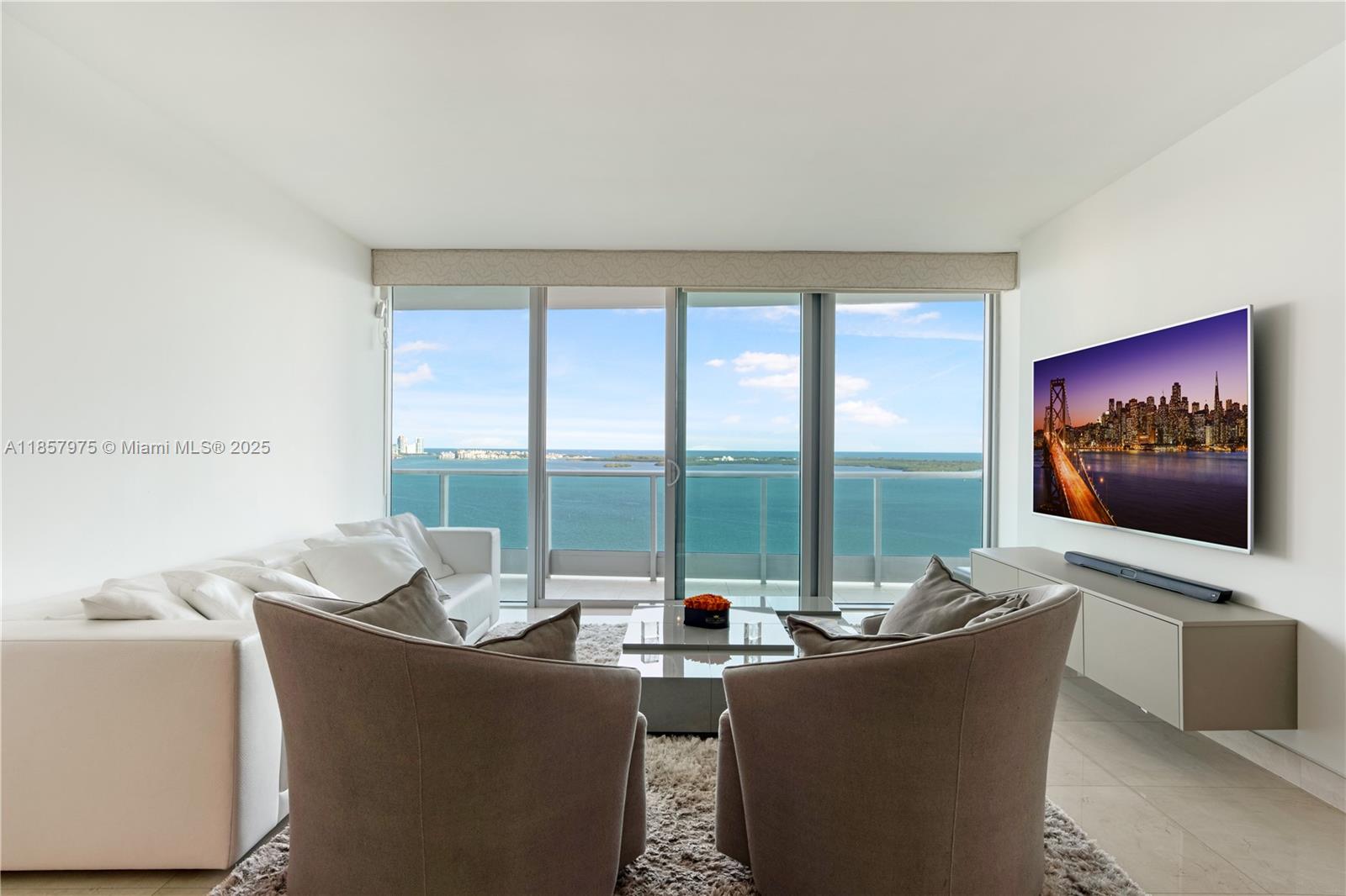 Stunning waterfront residence with breathtaking unobstructed views at the ultra-luxurious Jade Brickell. Spacious floor plan with a private foyer and elevator. Amazing den which could easily be converted to a 3 bedroom with its own connecting bathroom. The floors were recently upgraded to marble and the window treatments are motorised throughout. Amenities include an oversize fitness center, Spa and heated waterfront pools. Pet friendly and very quiet part of Brickell with easy access to I-95. Take a wonderful stroll at the bay front or to Brickell Key Island and Mary Brickell Village. Two assigned parking space. Complementary valet for guests. "Offered turn-key, with all designer furnishings thoughtfully included in the sale"