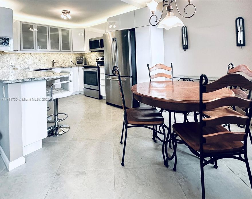 Seller Financing available.  Fully upgraded, freshly painted & beautifully maintained, this ground-floor condo offers a scenic view of the lake & private garden.  Remodeled kitchen with space for everything! Pantry with pull-out shelves, deep drawers & lazy-susan. Over-mount & under-mount lighting, stainless steel appliances, hidden storage under the countertop. Upgraded bathrooms & flooring.  AMAZING CLOSET SPACE in all 4 closets: 2 walk-ins, linen, hallway + a large patio storage room.  Parking space is in front of your door, giving a true home-like feel.  Plenty of guest parking.  Community features: Guard-gated, 24/7 security & shuttle bus service.  Clubhouse, theater, swimming pools + indoor heated pool, putting green, fishing pier, gym, library, tennis & pickleball, to name a few.