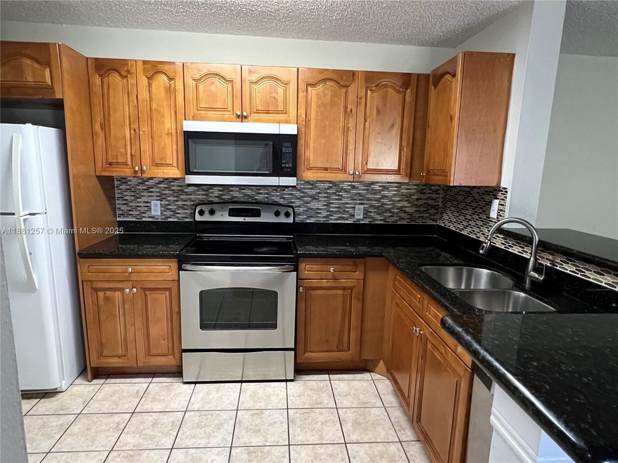 Apartment available in a great gated community over Atlantic Blvd, near main roads, schools, shopping center, and restaurants. Updated 3 bedroom and 2 bathroom corner unit with high ceilings, a balcony, open kitchen concept, stainless steel appliances, and granite counter tops. Unit has impact sliding glass door and laundry room. All floors are ceramic tile and bedrooms are laminate wood.  Amenities include tennis court, pool for kids and for adults, childrens play area, bbq area, and gym.  A 620 minimum credit is required by the association for approval. This unit is still tenant occupied.  It would be available by October 30th.  Please call listing agent for showing instructions.
