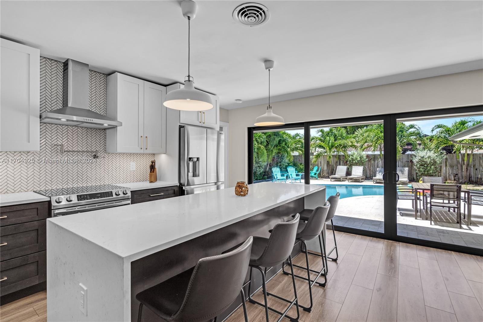 Stunning 3B/2B home in Imperial Point. Completely remodeled in 2020, Sleek & Modern, featuring impact windows & doors, open kitchen w/ quartz countertops with waterfall on both sides of the endless island & smart switches for modern living. Upgraded electric panel & Nest-controlled HVAC system. Fully remodeled bathrooms, floor & Kitchen. Step outside to your tropical retreat, complete with a travertine pool deck, a heated saltwater pool, fire pit, palm trees and tropical vegetation. Abundant closet space, bonus storage room, and spacious laundry room. Sprinklers, tankless water heater, and a water filtration system. Located near top-notch dining, shops, entertainment, 10min from Beaches. Perfect home or investment property. Turnkey furnished and with no rental restrictions!