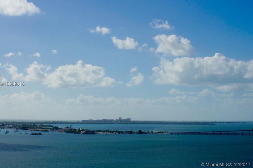 Island living & breath taking bay views from every room in this beautifully remodeled & elegantly furnished luxury condo. Enter thru double-doors to a direct bay view beyond the extra-long balcony. Kitchen has granite counters & breakfast table. Both bedrooms have bay views & walk-in closets. The master has a spacious en-suite & spa. Discerning residents enjoy a guard gated entry, 24hour security, fitness center, bay-front pool, BBQ area & more. 2 PARKING SPACES INCLUDED. Offered unfurnished if needed.