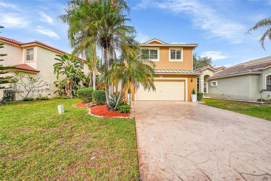 Showcasing nearly $200,000 in quality upgrades, this move-in-ready lakefront single family home offers refined design, thoughtful functionality, and a prime location within a guard-gated Coconut Creek community. This beauty shows like a model home, it has been meticulously enhanced with a brand-new metal roof, full impact windows, and sophisticated updates throughout.  The home’s centerpiece is a chef-inspired kitchen featuring custom cabinetry, a double wall oven, induction cooktop, and a seamless connection to open living and dining spaces, ideal for both everyday living and entertaining. Porcelain tile floors elevate the main level, while wood flooring upstairs provides warmth and elegance. The expansive primary suite feels like a private sanctuary, complete with a spa-style designer bathroom finished with high-end details and double walk-in custom closets.  Outdoor living is a true highlight, offering a screened patio with serene lake views, a fully fenced backyard, and a brand-new jacuzzi that extends enjoyment year-round. Set in a well-maintained, guarded community, this lakefront home combines comfort, quality, and lifestyle—delivering a rare opportunity for buyers seeking turnkey waterfront living.