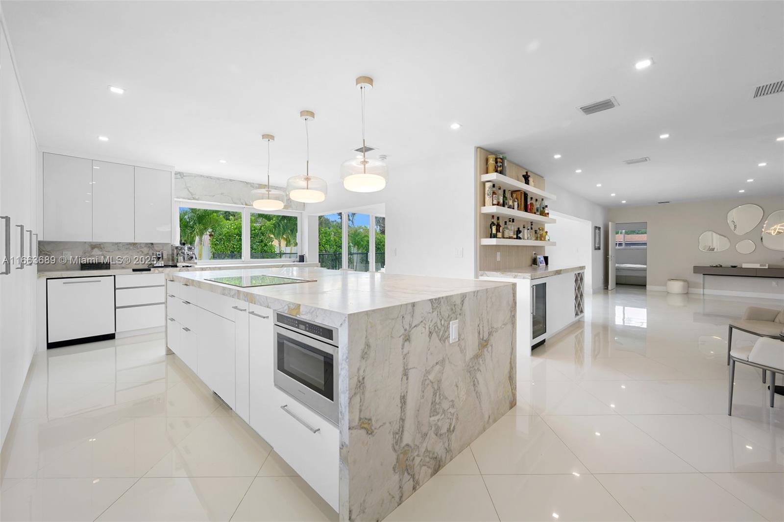 A Fully Designer Renovated and Decorated 4 bed / 3 bathroom + salt water pool home in the gated community of Highland Lakes. 2024 Metal Roof, Impact Windows w/Slidders, LED lighting. A chef's dream kitchen is equipped with an oversized island with a 9' island with Brazilian Dolomite double waterfall countertops, GE monogram / Miele appliances, an abundance of cabinet & counterspace, coffee and whiskey/wine bar/dual ovens and an entertaining paradise with a gorgeous bright Florida Room. Herringbone Italian porcelain tiles, solid wood doors, and the principal bath has a spa feel-completely renovated. Designer Italian Furniture Package sold seprately; includes Cattelan Italia leather, and more