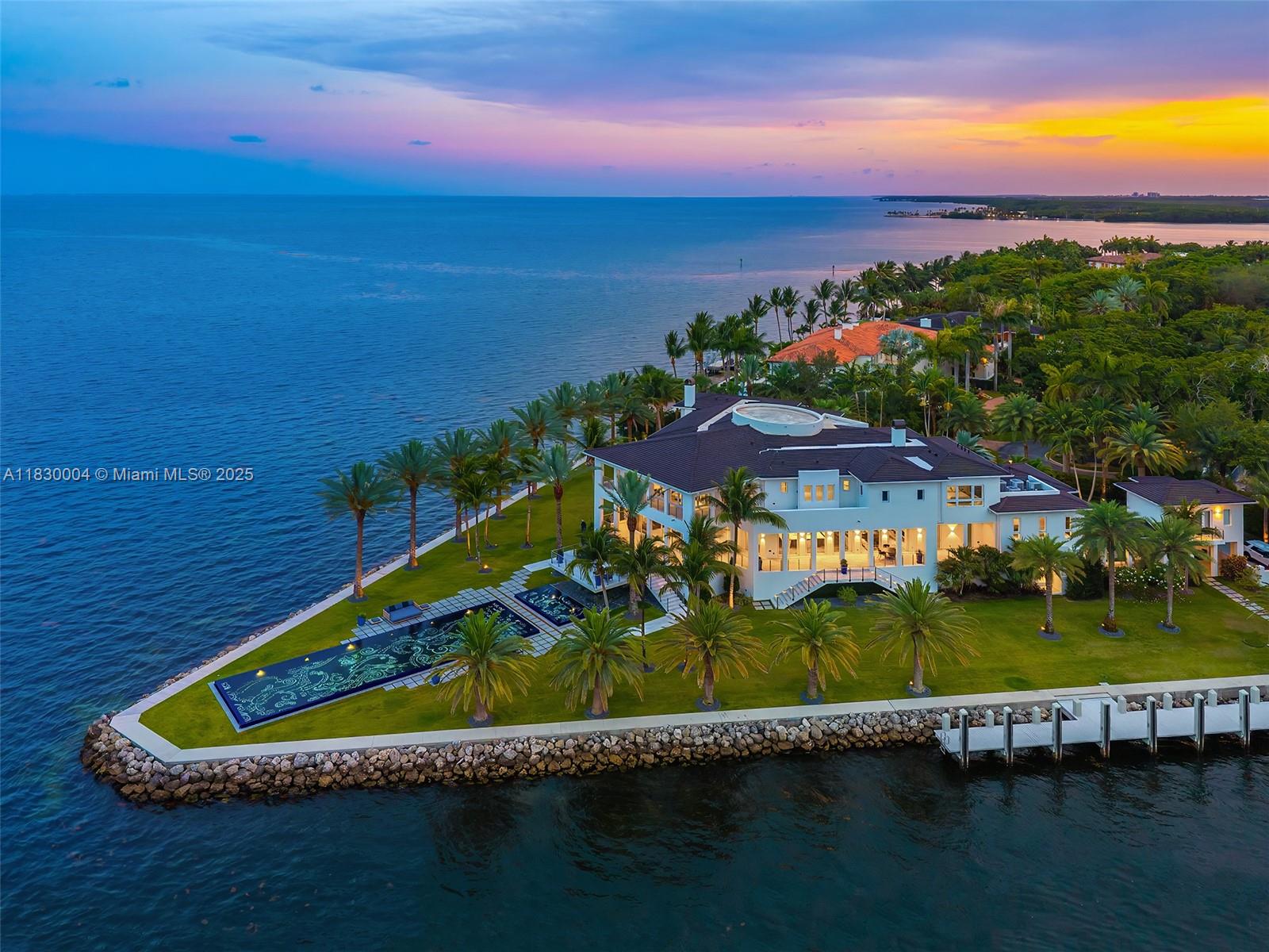 A generational estate on a 1.5-acre V-shaped peninsula, incomparable to any offering, presents an extraordinary 574' of prime waterfront in Gables Estartes, including a private 140'dock on protected waters. With jaw-dropping panoramas of Biscayne Bay, Miami skyline and Atlantic sunrises, it stands as a ture landmark, one of Miami's most iconic private residences. Designed by Ramon Pacheco, the manse includes a media room, wet bar, office, gym and a sanctuary suite w/spa bath, lounge, dressing room, all encompassed by bayfront terraces. A grand 62' pool by Estudio Arqué is framed by palm gardens. Chef kitchen curated by Mick De Giulio, and Italian maker Baxter furnishings offer turnkey luxury. 5-car garage with 2 climate-controlled bays,staff, gated+walled entry complete this legacy estate.