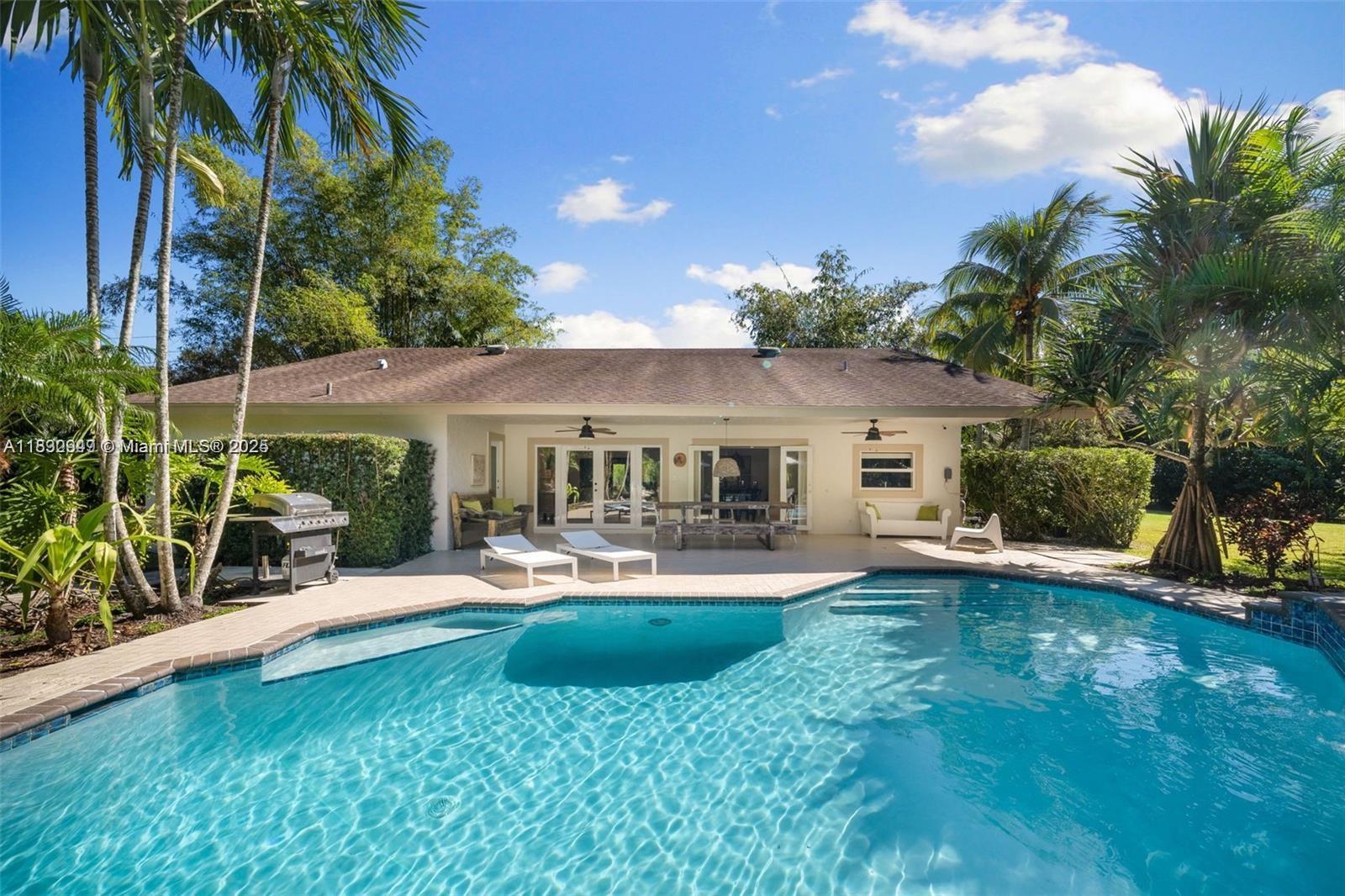 Step into your own gated sanctuary on 1.25 lush acres in prestigious SW Ranches. This tropical estate blends privacy, scale, and endless potential. Three separate entrances offer space for guest houses, pickleball, or equestrian living. Inside, dramatic ceilings and expansive open spaces set a grand tone, with a garage conversion adding total sq ft to 3059 creating a spacious 4th bedroom. Mature, curated landscaping surrounds a resort-style pool. Zoned for horses and nurseries, with room to build your dream compound. The rectangular layout, privacy, and serene setting make this a true hidden gem. Minutes from elite shopping, dining, and highways—yet it feels a world away. A rare opportunity to own a home that lives like a private resort—bold, beautiful, and unforgettable.