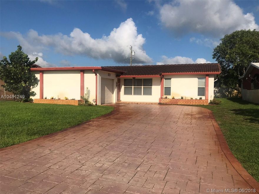 Welcome to this spacious three bedroom, two bath home on a quiet street.  This house has neutral tile in common areas, split bedrooms, main bedroom has a private bathroom, family room eat in kitchen and a garage. Enjoy the view of the large yard from your screened (new screen) enclosure that features roll out shutters.  This home has a new water heater, new washer and dryer, a new sprinkler pump, s tile roof and a spacious concrete stamp driveway which allows lots of parking. The kitchen and bathroom are neutral and the home has lots of light.  The spacious back yard backs up to a church parking and features a concrete wall for privacy.  This property is walking distance to drugstore, daycare and High School.  Very close to the highway.