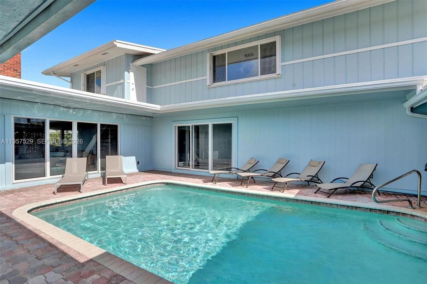 Stunning Beach–style residence blending timeless charm with modern upgrades. This beautifully maintained 6-bedroom, 3-bathroom two-story home offers an ideal layout with 2 bedrooms and 2 full bathrooms on the main level. Thoughtfully designed interiors feature first-floor entry, a spacious kitchen with island and snack bar, fireplace, walk-in closets, and elegant finishes throughout. High-impact windows, plantation shutters, and custom blinds enhance both style and functionality.

Step outside to a private tropical oasis with a beautiful  pool, expansive patio, open porch, and fully fenced backyard—perfect for entertaining or relaxing in complete privacy. Additional highlights include circular driveway, attached garage, exterior lighting, and serene garden and pool views. A rare opportunity to own a classic Florida home with exceptional indoor-outdoor living - Above Ground Jacuzzi Firepit - Furniture Available for purchase all you need is your toothbrush