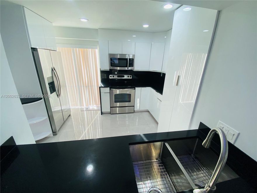 WELCOME HOME! This updated corner unit is located on the top floor, a spacious 2 bedroom 2 bathrooms with washer & dryer inside the apartment! Right off of the kitchen features a balcony to watch the sunsets or enjoy morning coffee. 1000+ square feet with plenty of closet space and storage throughout the apartment. Features: New impact windows, beautiful recessed lighting, stainless steel appliances, beautiful flooring throughout, & tankless water heater. Very secure building unit comes with 1 assigned parking space in a gated garage. Walking distance to schools, the baseball stadium, and retail stores located on the first floor of the building. Views of the Marlin Stadium and Downtown/Brickell. No Pets. Available May 15th.