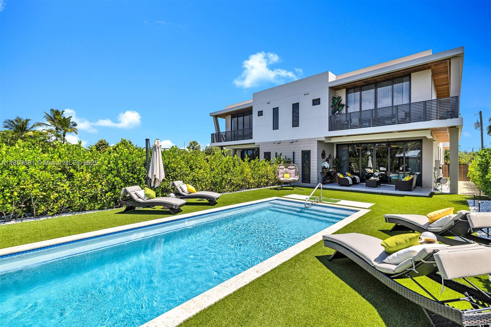 Built in 2024, this luxury twin home offers 3,385 sf of refined living space with 4 beds and 5 full baths. Designed with modern elegance, it features porcelain floors, high-impact windows, custom closet cabinetry, and soaring ceilings. The open-concept kitchen includes, all Thermador appliances, a butler’s pantry which connects to a 2-car garage. The exterior showcases coral stone and Brazilian teak, giving the home a striking tropical sophistication. Outdoor living includes a private pool, gazebo perfect for BBQ's, and lush, lighted landscaping. Fully gated for privacy, the home combines comfort with advanced amenities. Located near top schools, parks, and Miami attractions, it offers the perfect balance of luxury, convenience, and style for those seeking a move-in-ready modern residence.