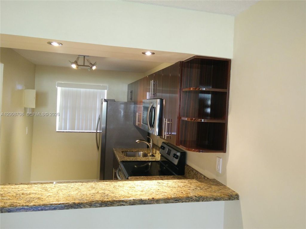 Photo of 3285 Foxcroft Rd #E107, Miramar, FL 33025 (MLS # A12008708)