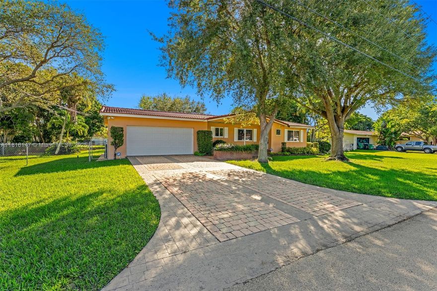 **PRICE ADJUSTMENT** Lovely and well maintained home in Palmetto Bay, nestled on a quiet street in a highly desirable area and a sought-after neighborhood. Over 15,000 sq ft private lot on a canal with room to expand and an oversized 2-car garage with storage space. This residence has over 2,016 sq ft under air as per homeowners with the following upgrades: *Barrel tile roof (2014) *Impact window and doors including garage (2018) *New A/C and tankless water heater (2023) *KitchenAid appliances (2017-2023)  *GE Washer & dryer (2023-2024) Features include real wood kitchen cabinets, granite countertops, fresh interior paint, and alarm system in place. This is the perfect home for a growing family or empty nesters looking to downsize. SELLERS WANT OFFERS!