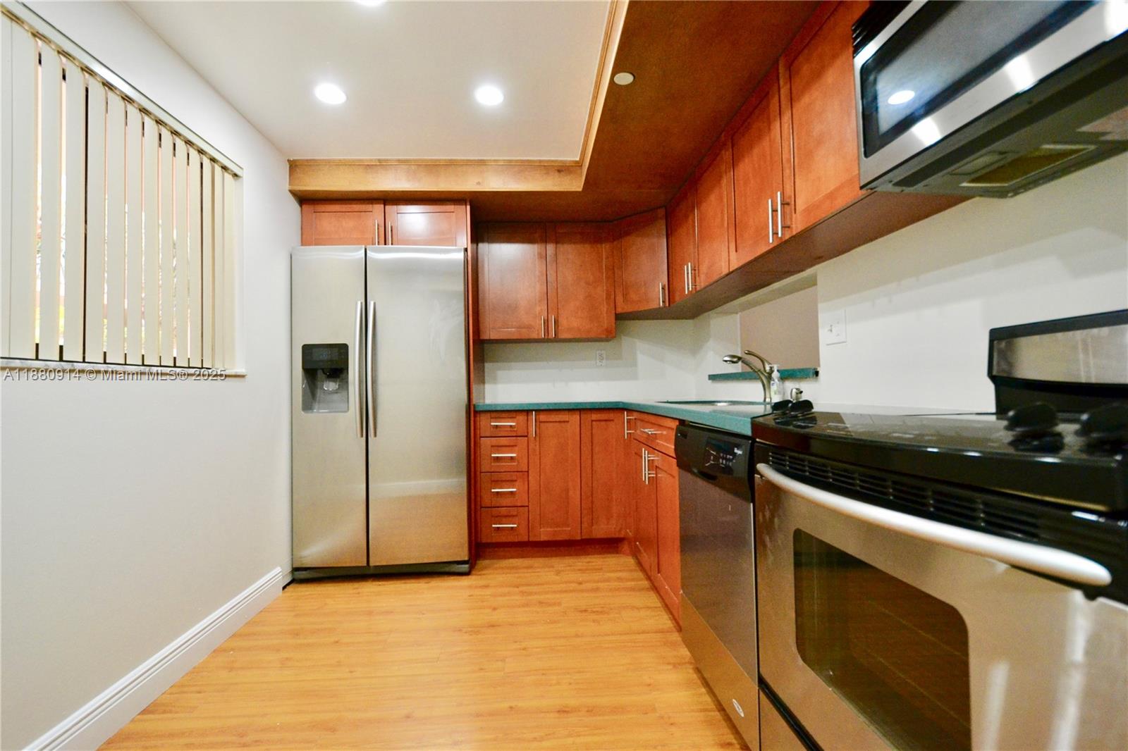 Ready to move in! Freshly painted 2-bedroom, 2-bathroom unit with laminate wood floors throughout. Features a large screened balcony with storage, assigned parking, and plenty of guest parking. Located in the well-maintained Horizon West community, offering excellent amenities including a clubhouse, four pools, racquetball, tennis, and basketball courts, BBQ area, laundry facilities, gated entry, and 24-hour security.