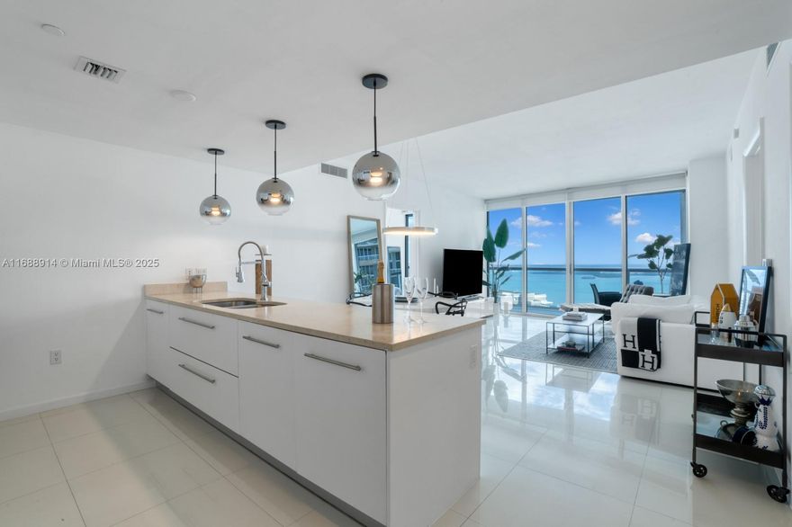 Perched on the 39th floor, this elegant 2-bedroom, 2-bathroom plus den residence in the coveted 07 line at ICON Brickell offers 1,290 SF of sophisticated living space with two expansive terraces that frame sweeping views of the ocean, bay, and city skyline. Inside, enjoy a fully updated kitchen with high-end appliances, abundant storage, new lighting, fresh paint, a new A/C, and a washer/dryer. Floor-to-ceiling windows flood the space with natural light, and spacious closets add convenience to this sky residence. ICON Brickell’s exceptional amenities include a world-class fitness center, lavish spa, three pools, a private dock, restaurants, and a movie theater—just steps from Brickell City Centre, Whole Foods, and fine dining destinations.