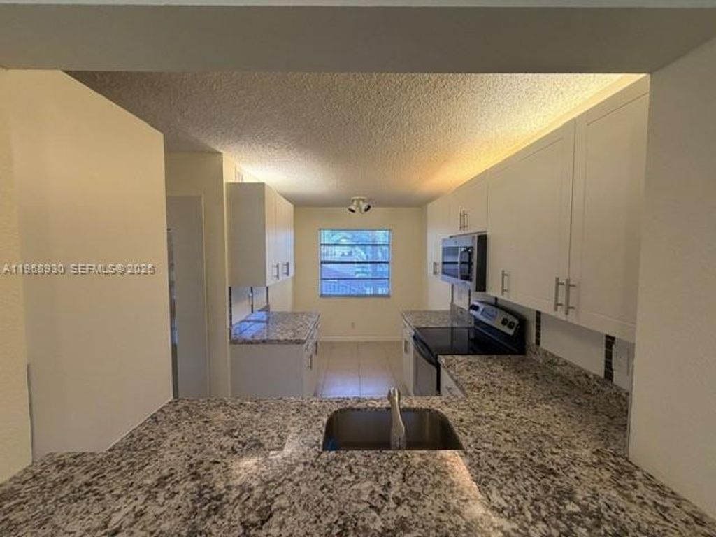 Photo of 2071 Coral Ridge Dr #N204, Coral Springs, FL 33071 (MLS # A11968930)