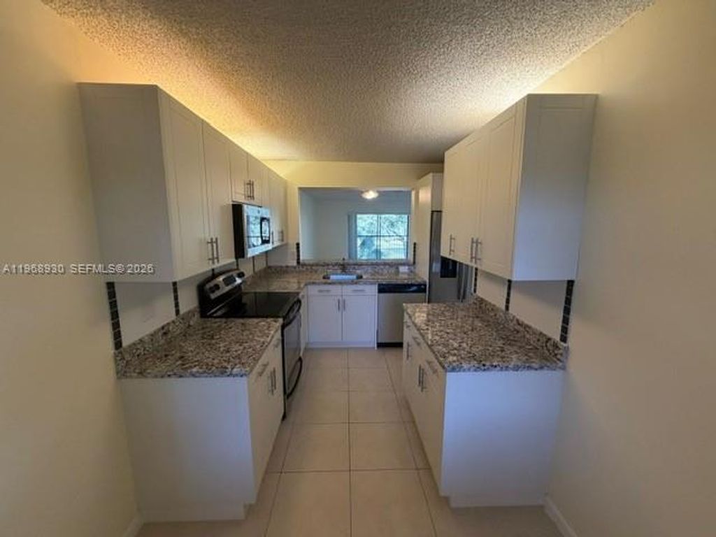Photo of 2071 Coral Ridge Dr #N204, Coral Springs, FL 33071 (MLS # A11968930)