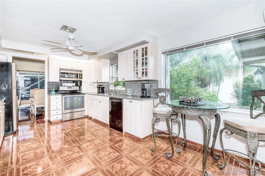 Country Club community w/2 golf courses. Granite and new wood cabinetry in kitchen with large wall pantry with slide out drawers. Loads of storage! Eat in kitchen. Separate utility room w/stainless sink. 2.5 car garage and separate golf car garage. Paved driveway. Beautiful pool area/totally screened. Guest bath has granite and under mount sink/new tile floor. Large sunk in living room overlooking pool area. Formal dining room overlooking pool. Lovely center foyer. Nice flow throughout house with hallway area separating bedrooms from living space. Great entertaining house. Wet bar with granite and new sink/faucet off living room. Quiet street/close proximity to Turnpike.