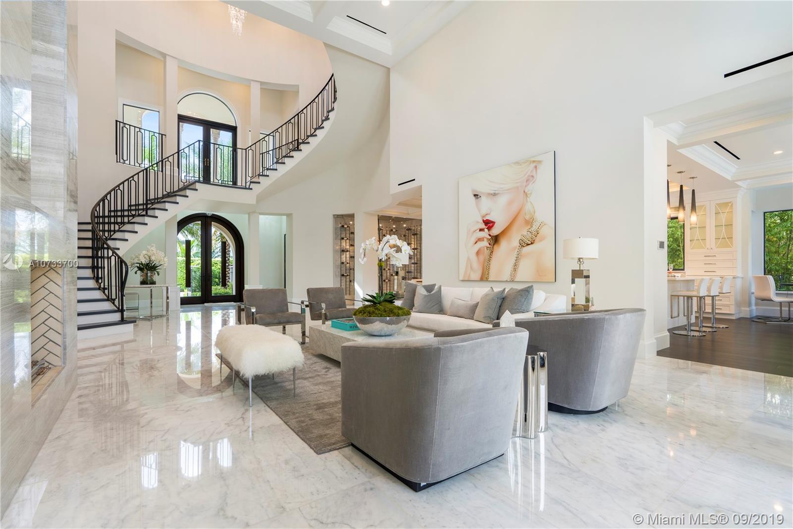 Come see the difference between this quality NEW custom built home versus a spec home. Gated waterfront estate with 75' waterfront, 3-story CBS, 5 bedroom/5 bathroom/1 half bathroom, Master bedroom suite on the 1st floor and 2nd floor, magnificent 3rd floor bonus room with Intracoastal waterway views, elevator, media room, floor to ceiling glass wine room, floor to ceiling gas fireplace, 36x36 marble throughout, 45x15 salt/heated pool with (gas) fire and water features. New concrete dock/pilings extended to 11' from seawall with new coral reef for turtles and sea-life. Cell phone controlled lighting/smart home, Hurricane impact windows and doors, 3-story foyer with spiral Italian wood staircase. Not a detail was missed on this custom home! A must see!
