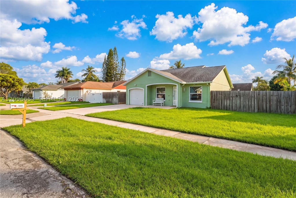 Photo of 1290 Mc Dermott Ln, Royal Palm Beach, FL 33411 (MLS # A12096659)