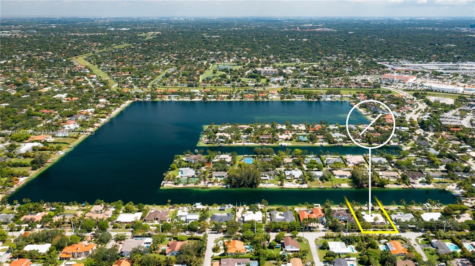 Join the lake-life in one of the most sought-after oasis in all Miami: E-Lake. Rarely for sale, now is the time to get on this 76-acre lake where you can ride on your boat, chase sunsets, & lay out on your own private beach every day! This desirable waterfront home features a brand-new dock with composite decking, a 12,000 lbs. boat lift, as well as a jet ski drive-on dock. Massive new chickee hut by the beach & summer kitchen under a lit trellis keeps summer going all year long. 4 bedrooms & 4 full bathrooms, including a brand-new primary suite with spa bath overlooking the priceless lake view. Impact glass & partial house generator provide peace of mind. Oversized garage & gated circular driveway round out this scenic home. Live your best life in this truly unique, Very Special Home.