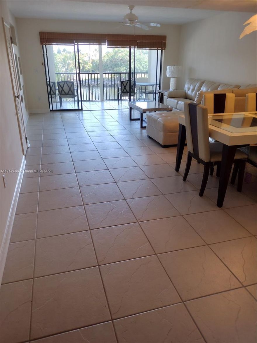 Beautiful, bright and airy, fully furnished 2/2.5 with DOCK! No fixed bridges and ocean access.  This townhouse is in Captain's Walk within the guard gated Pelican Harbor. Apartment backs up to the C-15 canal and has expansive water views from 2 balconies.  Main bedroom has unobstructed water views.  Second bedroom has 2 full sized daybeds with trundles for additional sleeping areas, 2 large closets and separate en suite bathroom.  All windows have plantation shutters. Washer & dryer in the unit. Carport for 1 car, another car can park uncovered & plenty of guest parking. Cable, internet and water included. Well maintained community has tennis courts/pickleball courts, 2 heated pools, exercise room, tiki hut, party room and barbeque areas.  Just bring your personal items and make it yours!