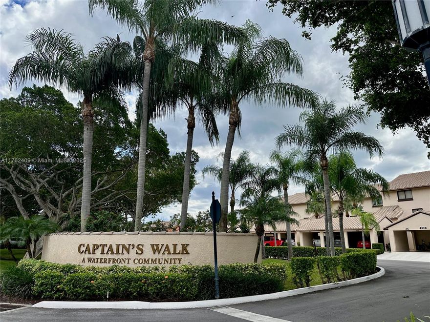 Waterfront home for you & your large boat! 2/2.5 townhouse is in Captain's Walk within the guard gated Pelican Harbor. Home backs up to the C-15 canal, has expansive water views from 2 balconies. Main bedroom has unobstructed water views including private dock for large boat.  Second bedroom has 2 full sized daybeds with trundles for additional sleeping areas, 2 large closets & separate bathroom.  All windows have plantation shutters. Washer & dryer in the unit. Carport for 1 car, another car can park uncovered & plenty of guest parking. Cable, internet & water included. Well maintained community has tennis/pickleball courts, 2 heated pools, exercise room, tiki hut, party room & barbeque areas. No fixed bridges & ocean access. Dock with water/elec for a large boat is available purchase.