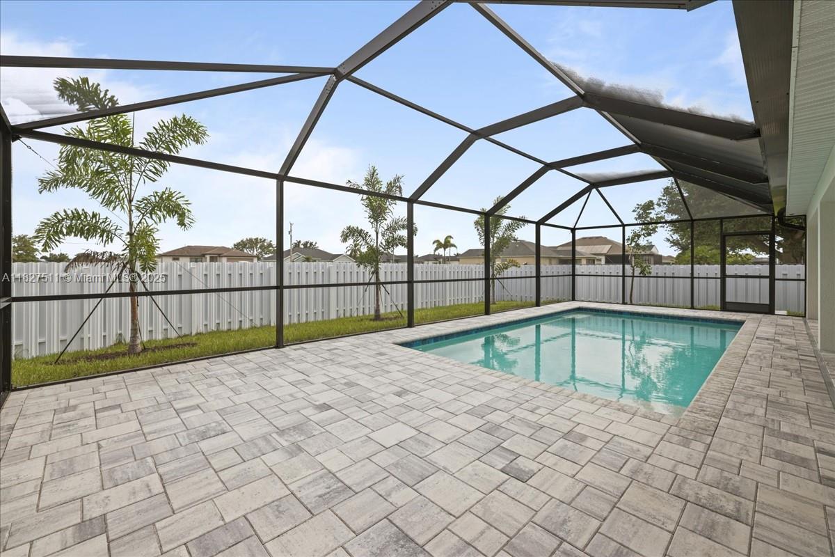 $15,000 BUILDER PAID CLOSING COSTS! BRAND NEW POOL HOME WITH PRIVACY FENCE – THE PARADISE COVE This spacious 4-bedroom, 3-bath home includes TWO PRIMARY SUITES, each with a full ensuite bath, ceiling fans, and walk-in closets, ideal for multi-generational living or hosting guests in style. The open-concept floor plan seamlessly flows into the huge lanai and paver patio, where your sparkling heated pool awaits, perfect for year-round enjoyment. At the heart of the home is a gourmet kitchen, featuring stainless steel appliances, all-wood, soft-close cabinetry, quartz countertops, a large island with breakfast bar, and a spacious pantry. Enjoy the peace of mind that comes with NO FLOOD ZONE & IMPACT WINDOWS, meaning lower insurance costs and greater security! This is the Paradise Cove Plan.