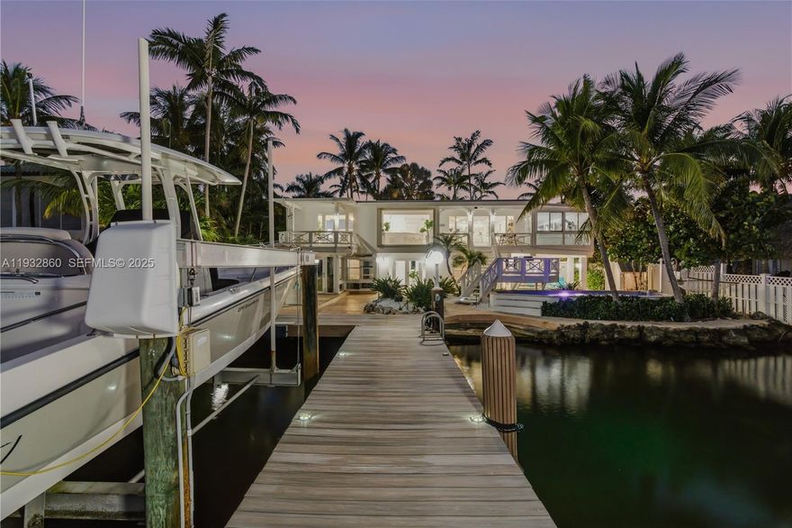 Stunning bayfront retreat in a sought-after subdivision of Key Largo, MM105.5, offering privacy, abundant natural light, and a refined Florida Keys lifestyle with convenient access to Miami. This contemporary waterfront residence features an open, airy layout with 3 bedrooms and 4 bathrooms, spacious studio and in-laws quarter- both its own entrance designed for comfort and relaxation.

The sleek, modern kitchen flows seamlessly into expansive living areas, creating an ideal setting for entertaining or everyday living. Large windows frame endless open-water views, while generous indoor-outdoor spaces invite you to enjoy poolside living and breathtaking bayfront scenery.

Boating and fishing enthusiasts will appreciate the new private dock with a 13,000-lb boat lift, perfectly suited for a 27-ft Boston Whaler. The boat is also available for purchase, offering a turnkey waterfront lifestyle with direct bay access and easy ocean access. A rare opportunity for those seeking modern design, open water, and exceptional boating in the Florida Keys.