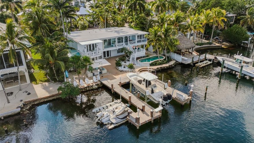 Stunning bayfront retreat in a sought-after subdivision of Key Largo, MM105.5, offering privacy, abundant natural light, and a refined Florida Keys lifestyle with convenient access to Miami. This contemporary waterfront residence features an open, airy layout with 3 bedrooms and 4 bathrooms, spacious studio and in-laws quarter- both its own entrance designed for comfort and relaxation.

The sleek, modern kitchen flows seamlessly into expansive living areas, creating an ideal setting for entertaining or everyday living. Large windows frame endless open-water views, while generous indoor-outdoor spaces invite you to enjoy poolside living and breathtaking bayfront scenery.

Boating and fishing enthusiasts will appreciate the new private dock with a 13,000-lb boat lift, perfectly suited for a 27-ft Boston Whaler. The boat is also available for purchase, offering a turnkey waterfront lifestyle with direct bay access and easy ocean access. A rare opportunity for those seeking modern design, open water, and exceptional boating in the Florida Keys.