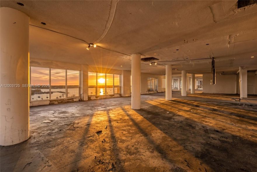 The Most Unique Property in All of Miami. A true blank canvas in the sky—this one-of-a-kind penthouse offers approximately 8,000 SF of interior space and 2,000 SF of exterior terraces, with unobstructed 360° panoramic views spanning the entire Miami skyline, including Downtown. Currently delivered as a raw, open-volume shell with no interior walls, the residence is wrapped in floor-to-ceiling glass, flooding the space with natural light and offering breathtaking views in every direction. This is a rare opportunity to design and build a completely custom environment tailored to your vision. Zoned for both residential and commercial use, the possibilities are expansive, whether envisioned as a private residence, luxury live/work space, spa, gym/yoga studio or a statement commercial concept. With a storied past, the property was once a nightclub and lounge reportedly frequented by Frank Sinatra, adding a layer of legacy and cultural significance. Positioned atop a mixed-use building, the penthouse offers a unique sense of privacy, scale, and flexibility rarely found in Miami. Potential uses include: Private Residence • Live/Work Concept • Lounge • Restaurant • Recording Studio • Gallery • Wellness Space • Creative Studio • and more. For the visionary buyer ready to create something truly iconic—this is your opportunity to shape a piece of Miami’s future. LOW HOA $1900 + $2200 IN ASSESSMENTS. 3 FOLIOS.
