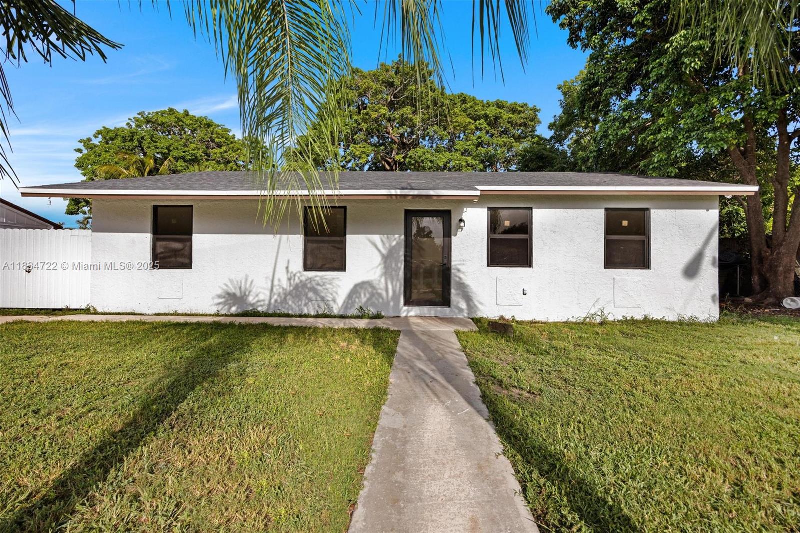 Welcome to this move-in ready and completely remodeled property with a new modern state-of-the-art kitchen that includes quartz countertops, new porcelain tile flooring throughout, upgraded bathrooms with walk-in showers, Hi-Hat lighting, new privacy fence around and impact windows and doors. Property is very close to the turnpike about 5 minutes and also features an open layout concept with the roof from 2022. Amazing big and delicious mangos tree is available to enjoy.